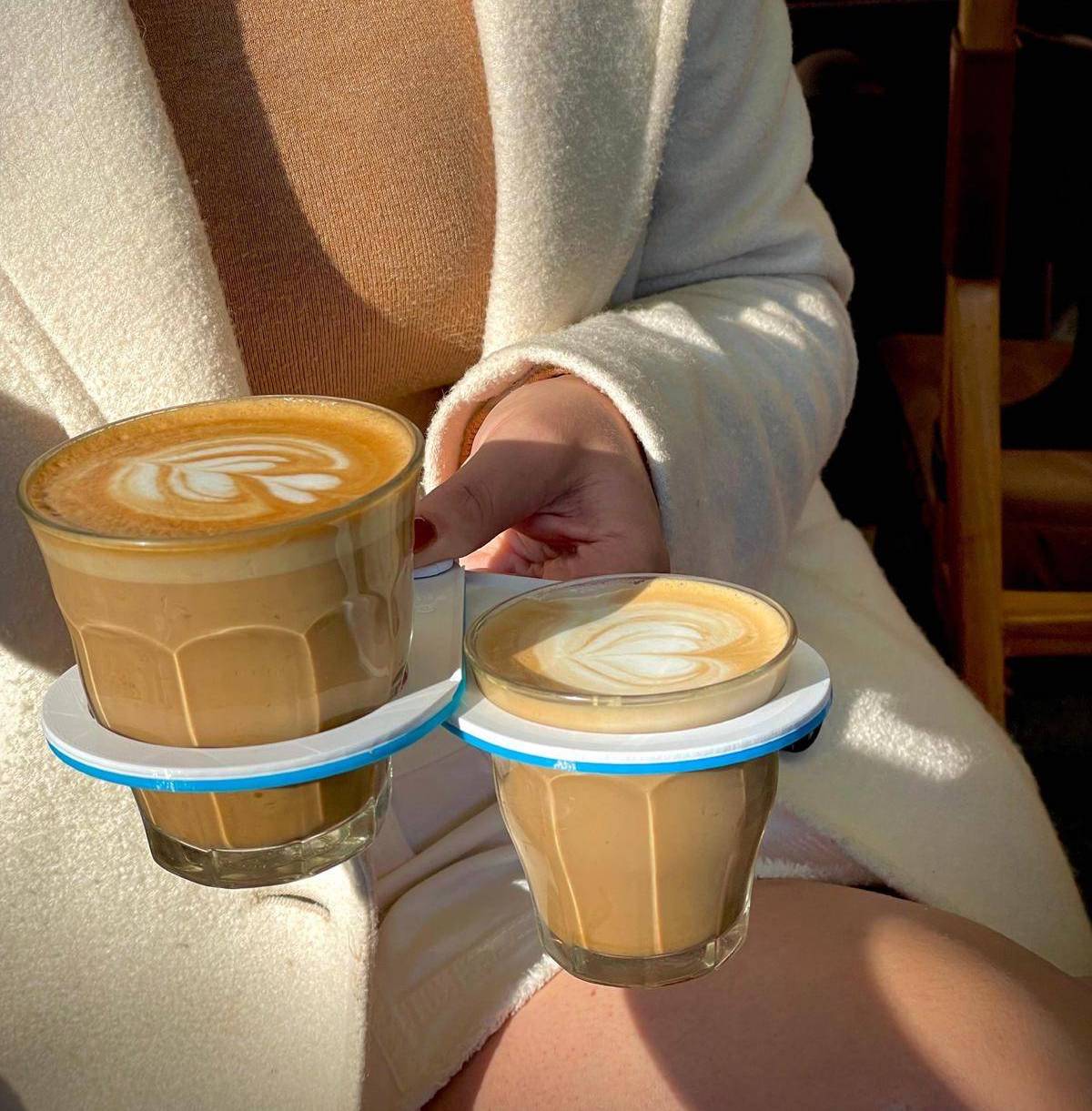 CarryMate environmentally friendly coffee cup carrier, blue and white custom design, woman carrying two coffee cups