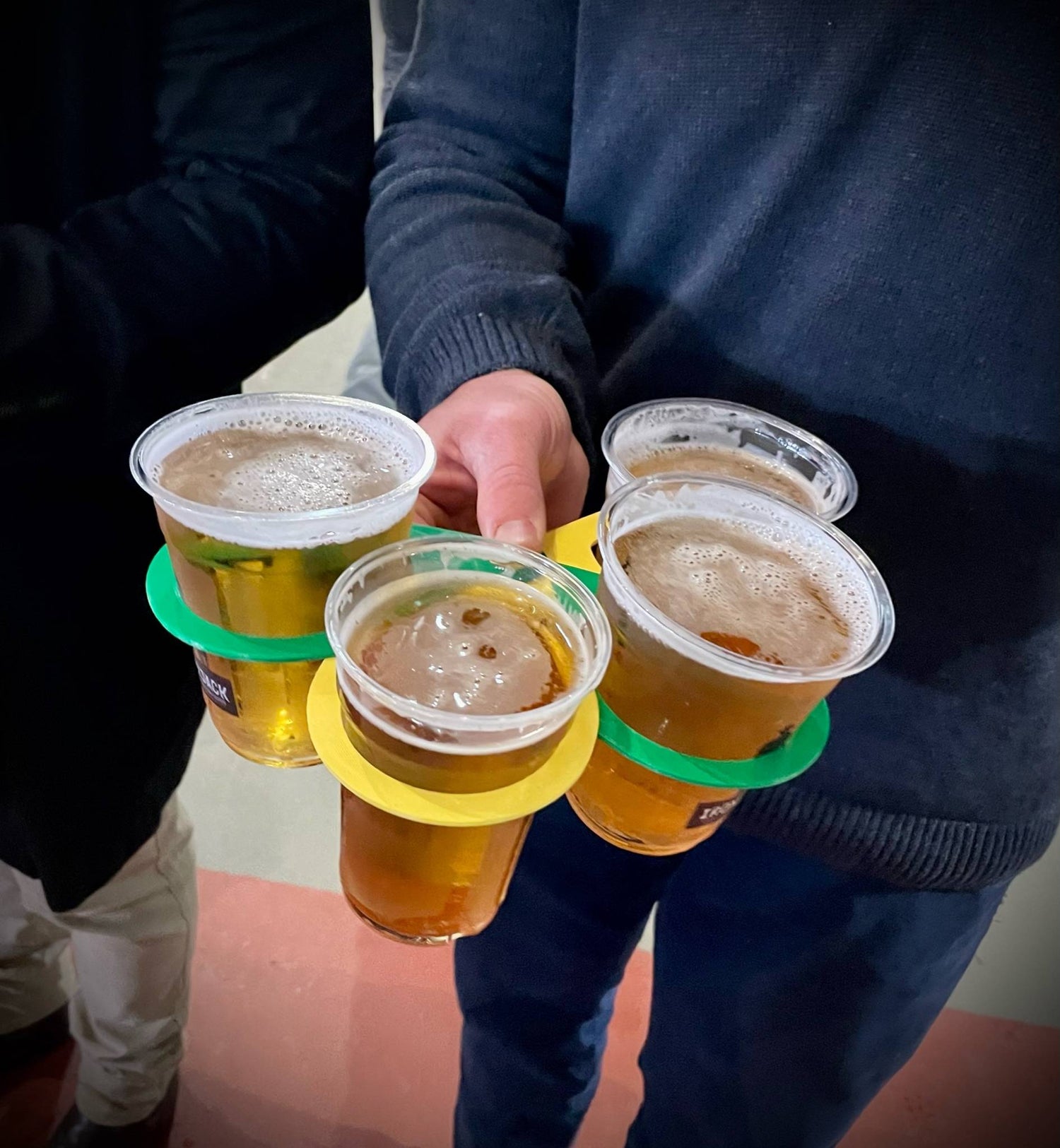 CarryMate environmentally friendly drink carrier, view from above of man carrying four full beer cups